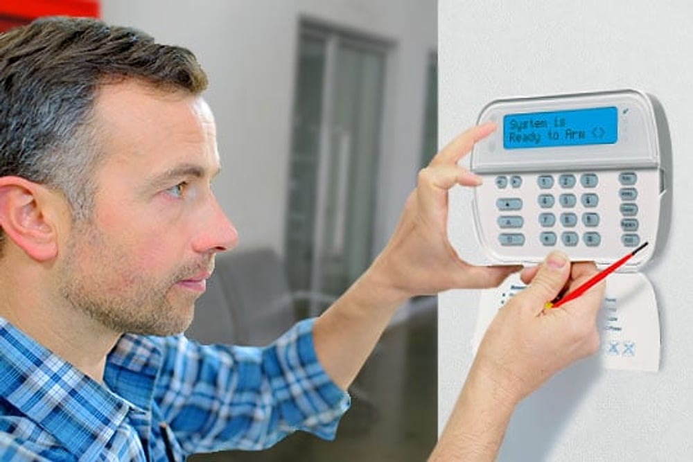 CCS technician configuring a DSC alarm control panel